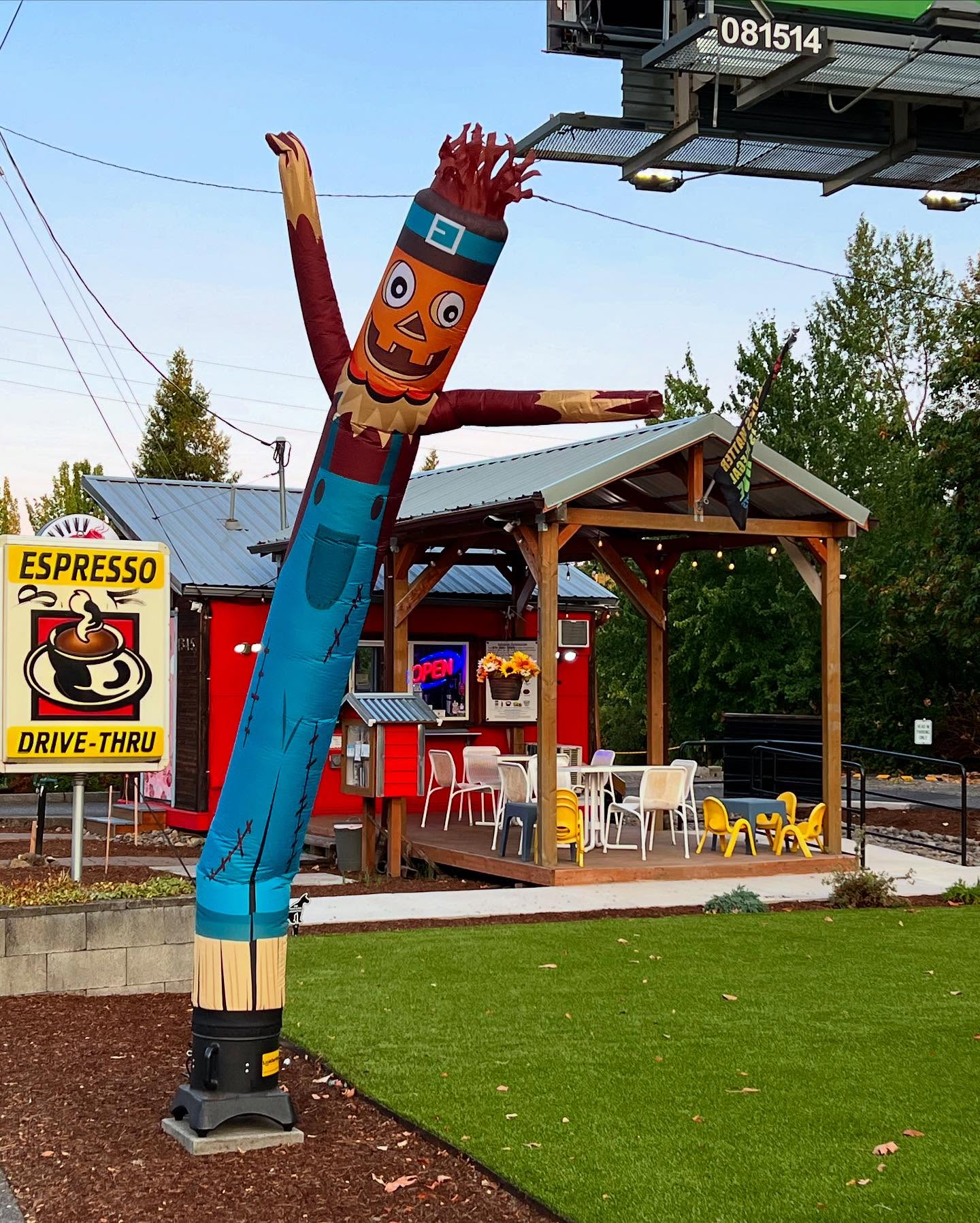 Slowbomb Coffee outdoor seating with colorful picnic tables under covered patio